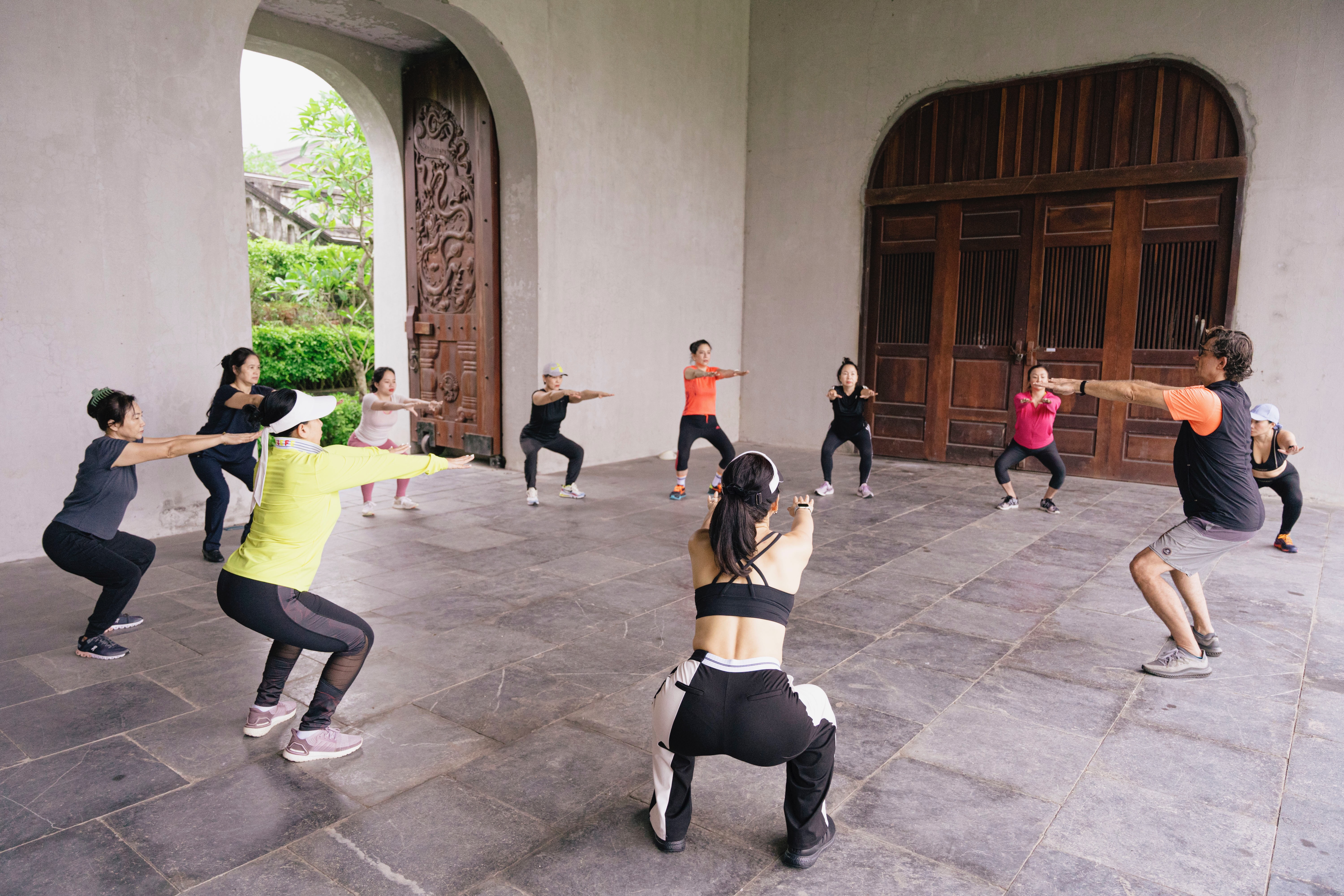 Vietnam Detox guests practising squats during a movement session