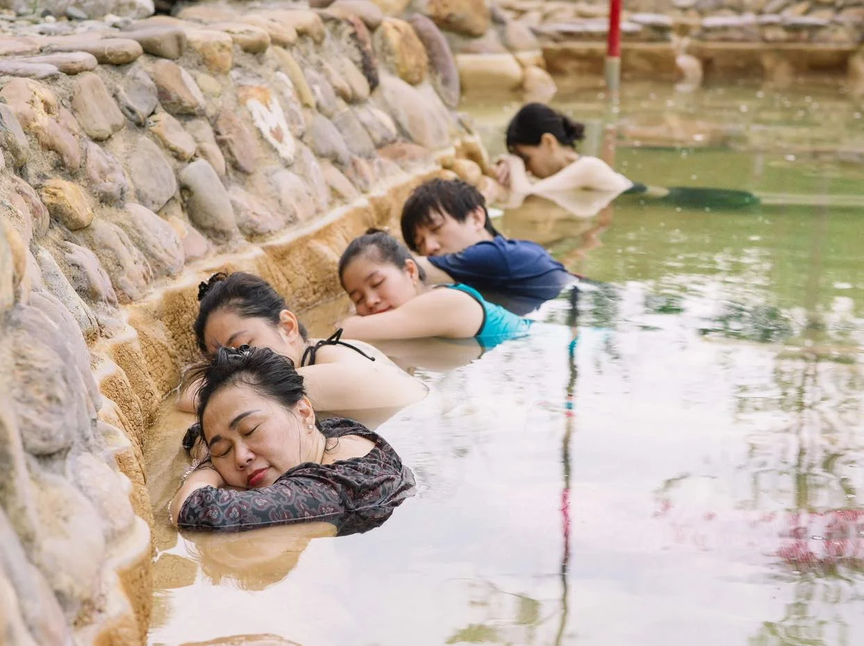 Guests unwinding in a mineral spring pool