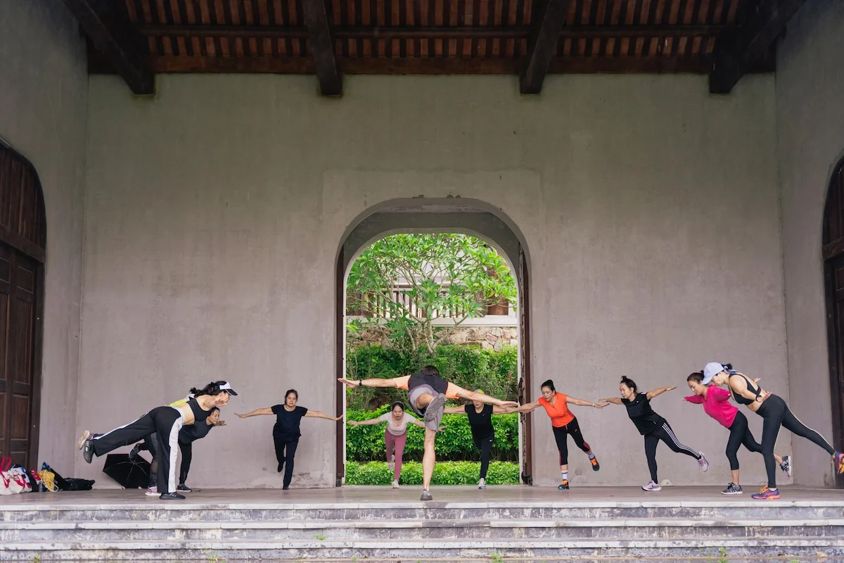 Morning movement class in the open courtyard at Legacy Yên Tử